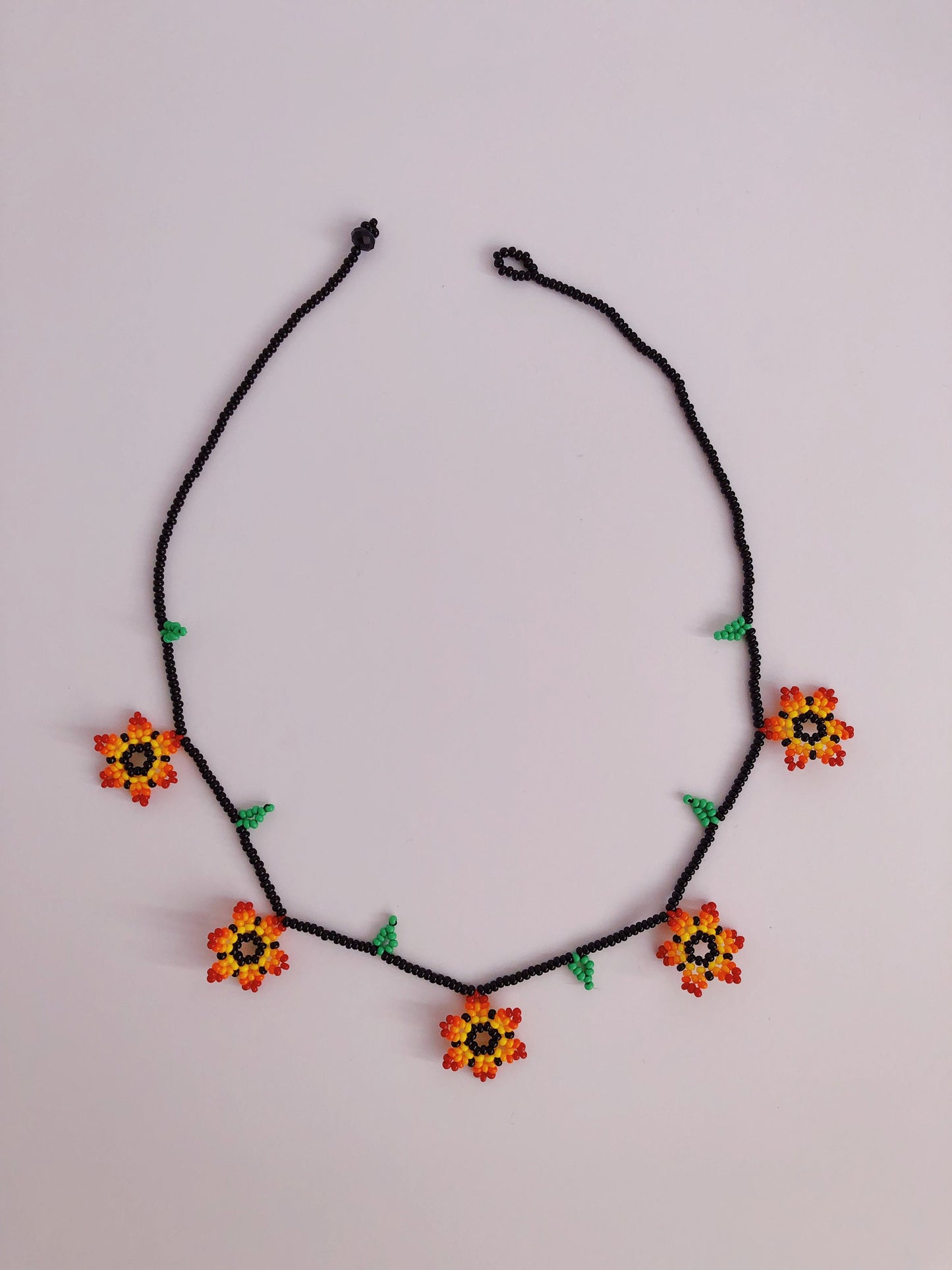 Collares de cuentas con flores azules y naranjas