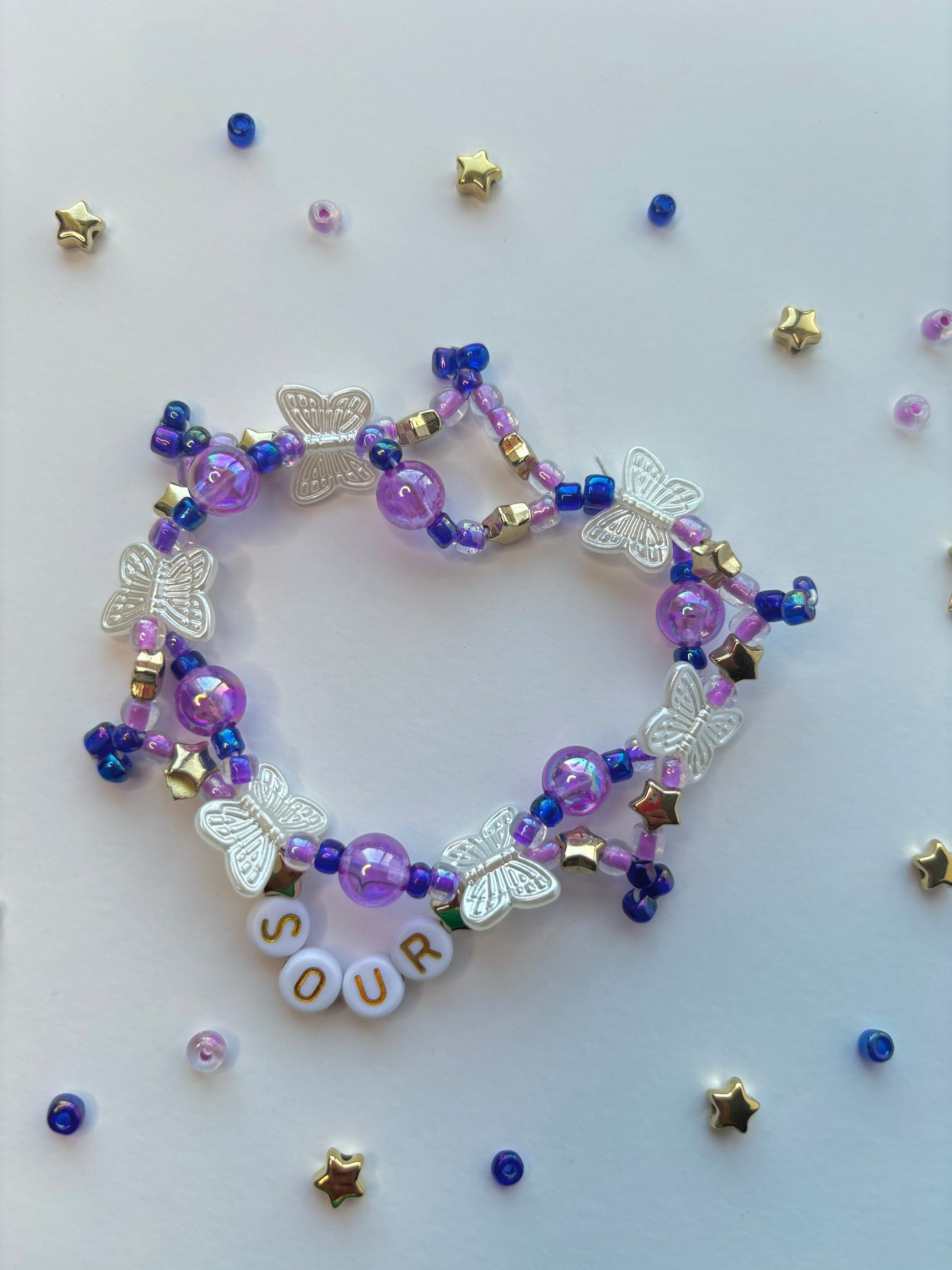 Olivia Rodrigo SOUR  beaded bracelet decorated with butterflies, stars, lettering and purple beads.